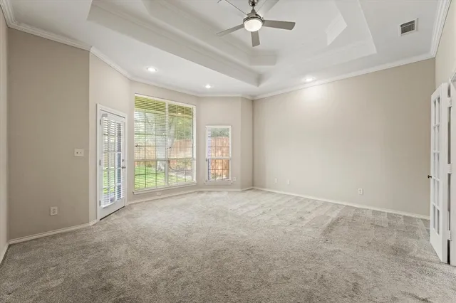 en empty room with windows and fan