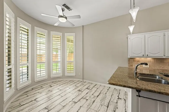 a bathroom with a sink vanity granite tub and shower