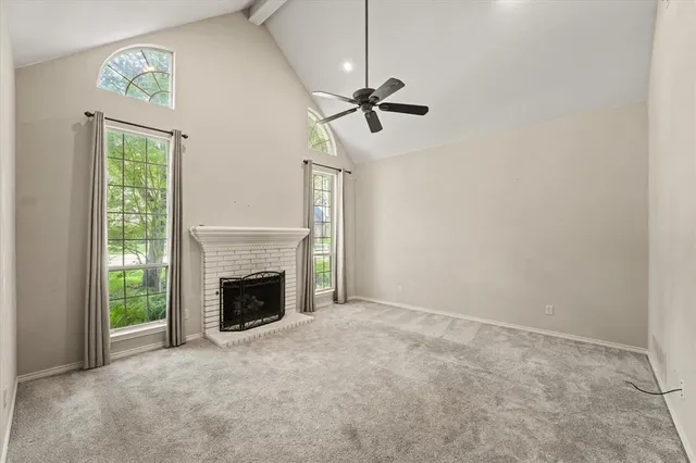a view of empty room with fireplace and fan