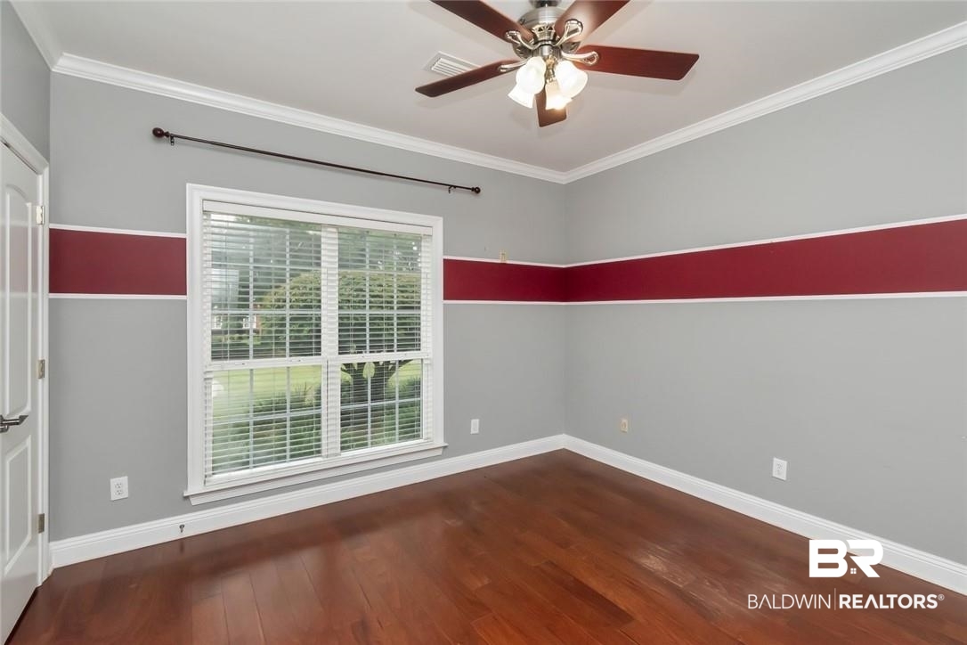 8837 Dawes Lake Road South Mobile, AL 36619 - Photo 24 of 44 Empty room with ceiling fan, dark hardwood / wood-style flooring, and ornamental molding