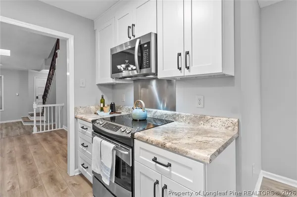 a kitchen with stainless steel appliances granite countertop a sink and a stove