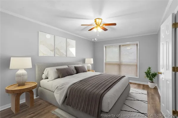 a bedroom with a bed and a painting on the wall