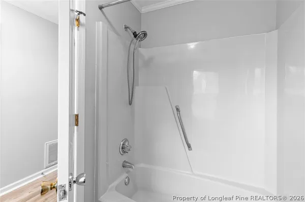 a bathroom with a shower and a tub