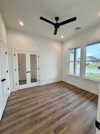 a view of an empty room with a window and fireplace
