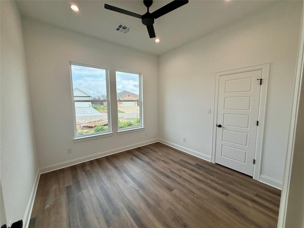 10400 T T Bury Lane Waco, TX 76708 - Photo 12 of 22 a view of a room with wooden floor and windows