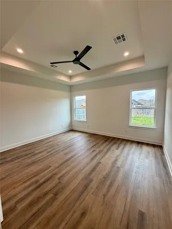 a view of a room with wooden floor and windows
