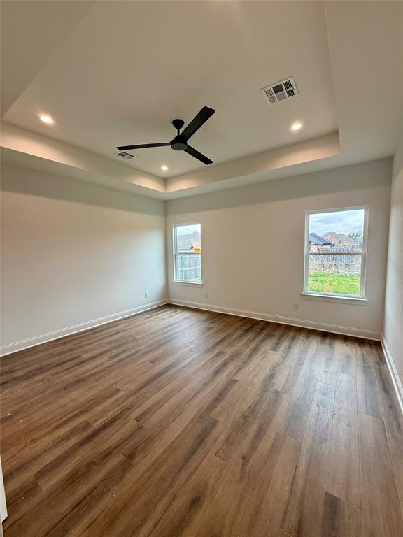 10400 T T Bury Lane Waco, TX 76708 - Photo 14 of 22 an empty room with wooden floor and windows