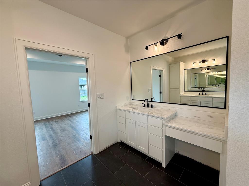 10400 T T Bury Lane Waco, TX 76708 - Photo 17 of 22 a bathroom with 2 sink and a mirror
