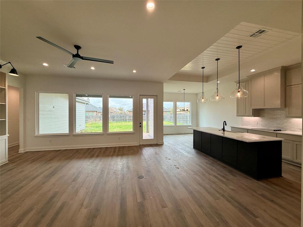 10400 T T Bury Lane Waco, TX 76708 - Photo 21 of 22 a large room with lot of large windows and wooden floor