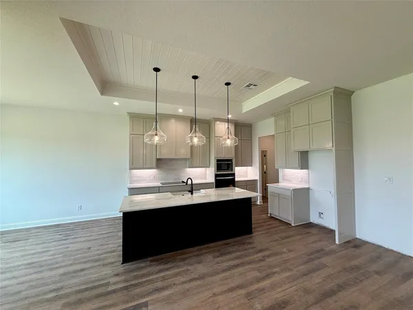 a large room with lot of large windows and wooden floor