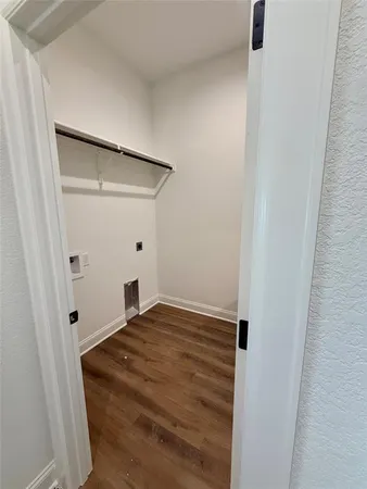 a kitchen with kitchen island a sink stainless steel appliances and wooden floor