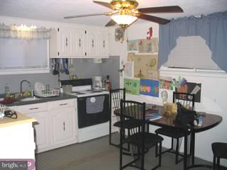 115 Somerset Road Glassboro, NJ 08028 - Photo 3 of 6 a kitchen with a dining table and chairs
