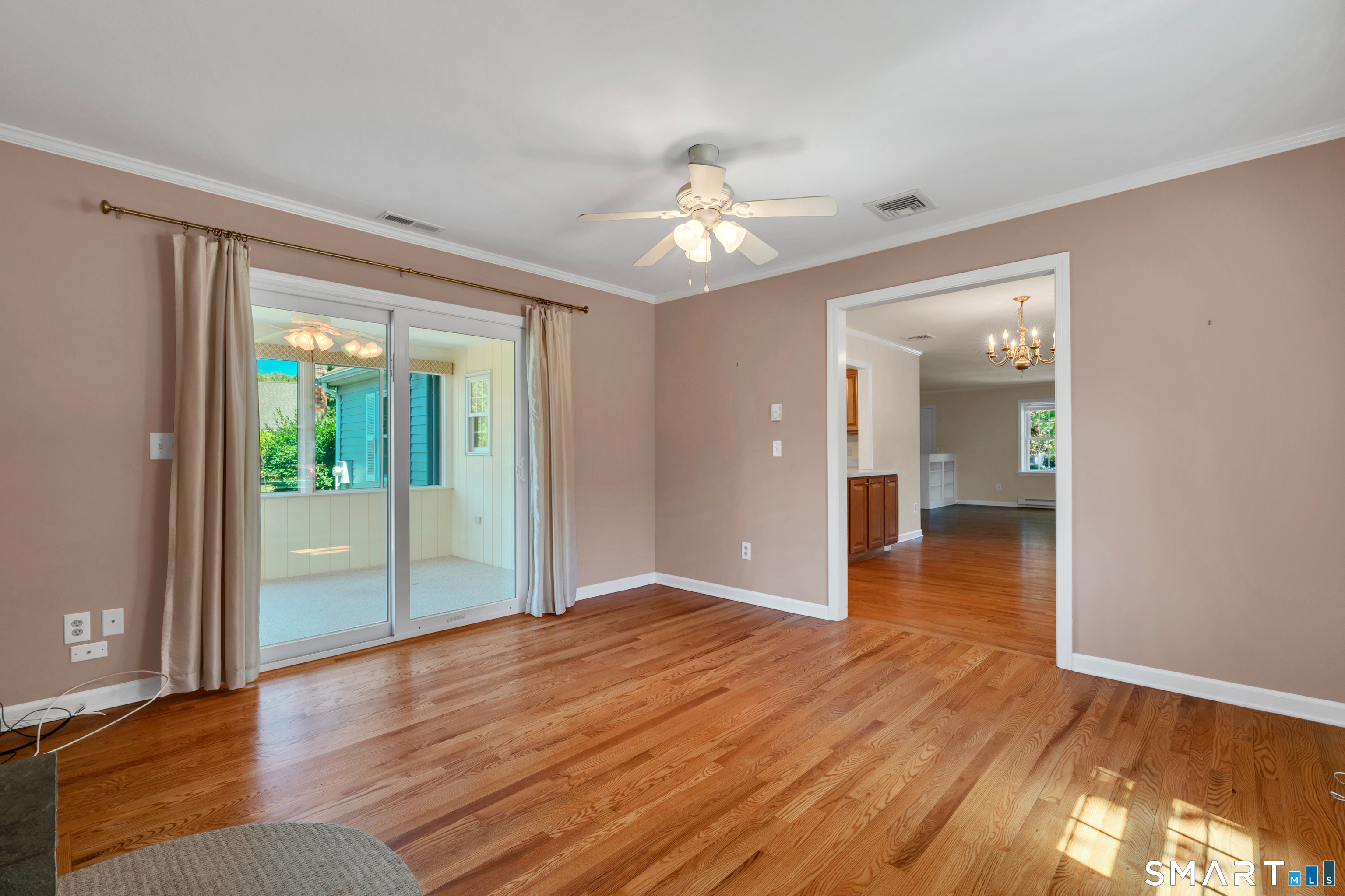 28 Downing Way, Unit 28 Madison, CT 06443 - Photo 7 of 30 Family room with fireplace and sliders to 3 season porch