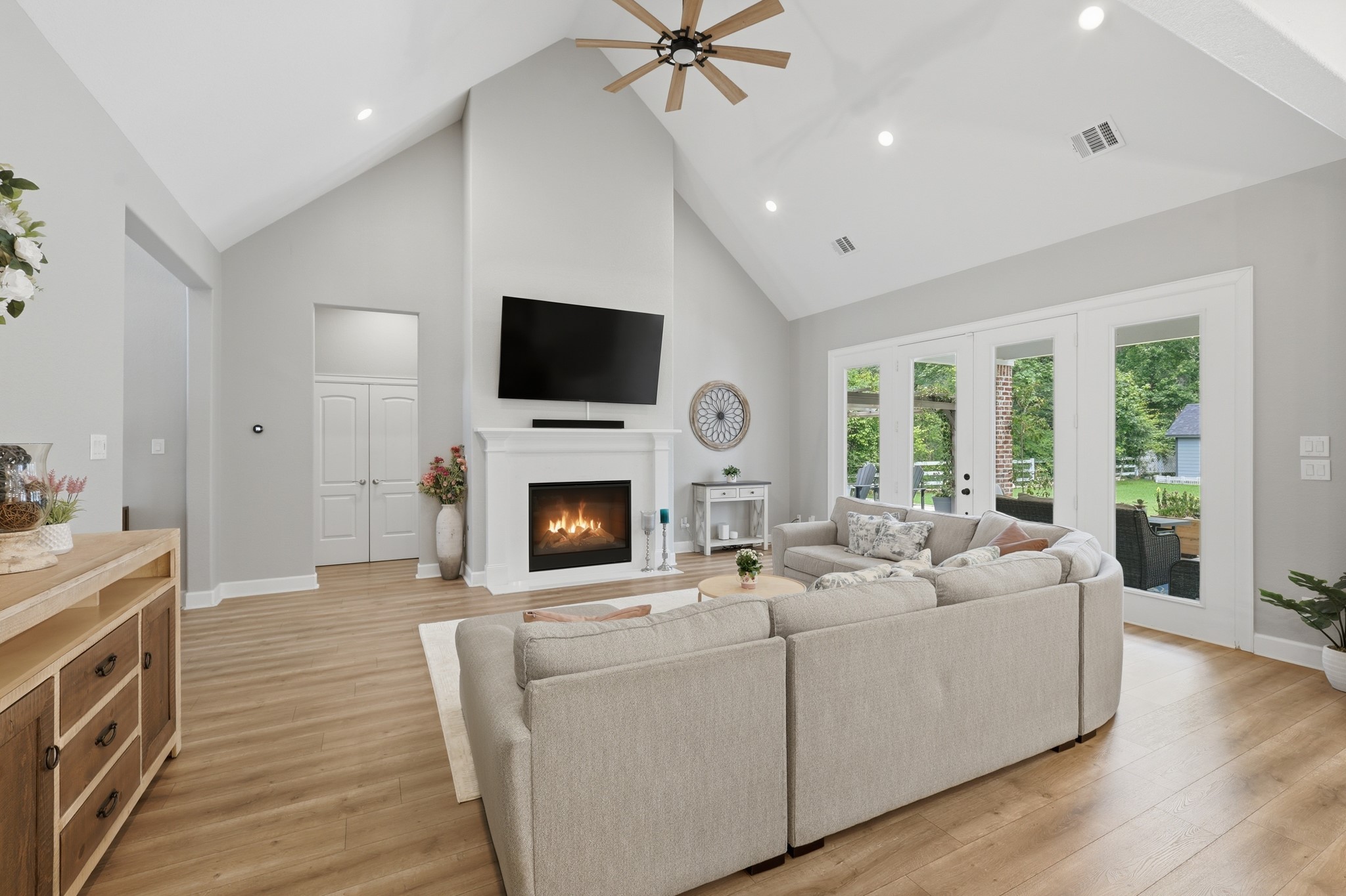 7106 Hampton Court Spring, TX 77389 - Photo 10 of 31 Living room with big windows and glass doors offer plenty of natural light and a beautiful view of the backyard, enhancing the spacious, open feel.