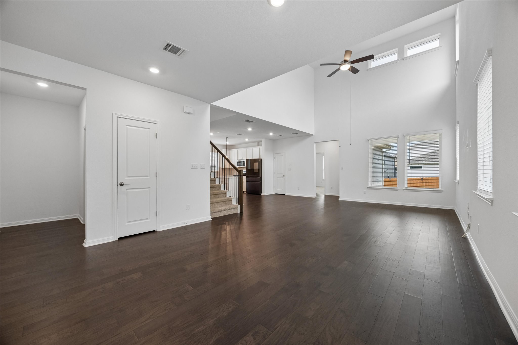 6407 Rounded Pebble Lane Buda, TX 78610 - Photo 4 of 32 A spacious, airy interior with soaring ceilings and rich hardwood flooring awaits new residents.