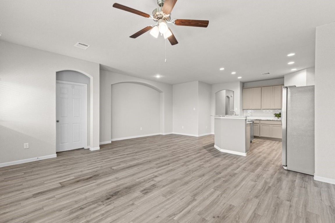 10139 Red Snapper Road Magnolia, TX 77354 - Photo 13 of 27 a view of a kitchen with wooden floor and a ceiling fan