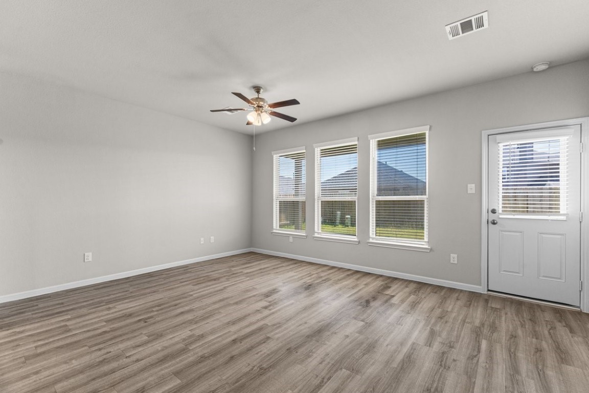 10139 Red Snapper Road Magnolia, TX 77354 - Photo 14 of 27 a view of an empty room with a window and wooden floor
