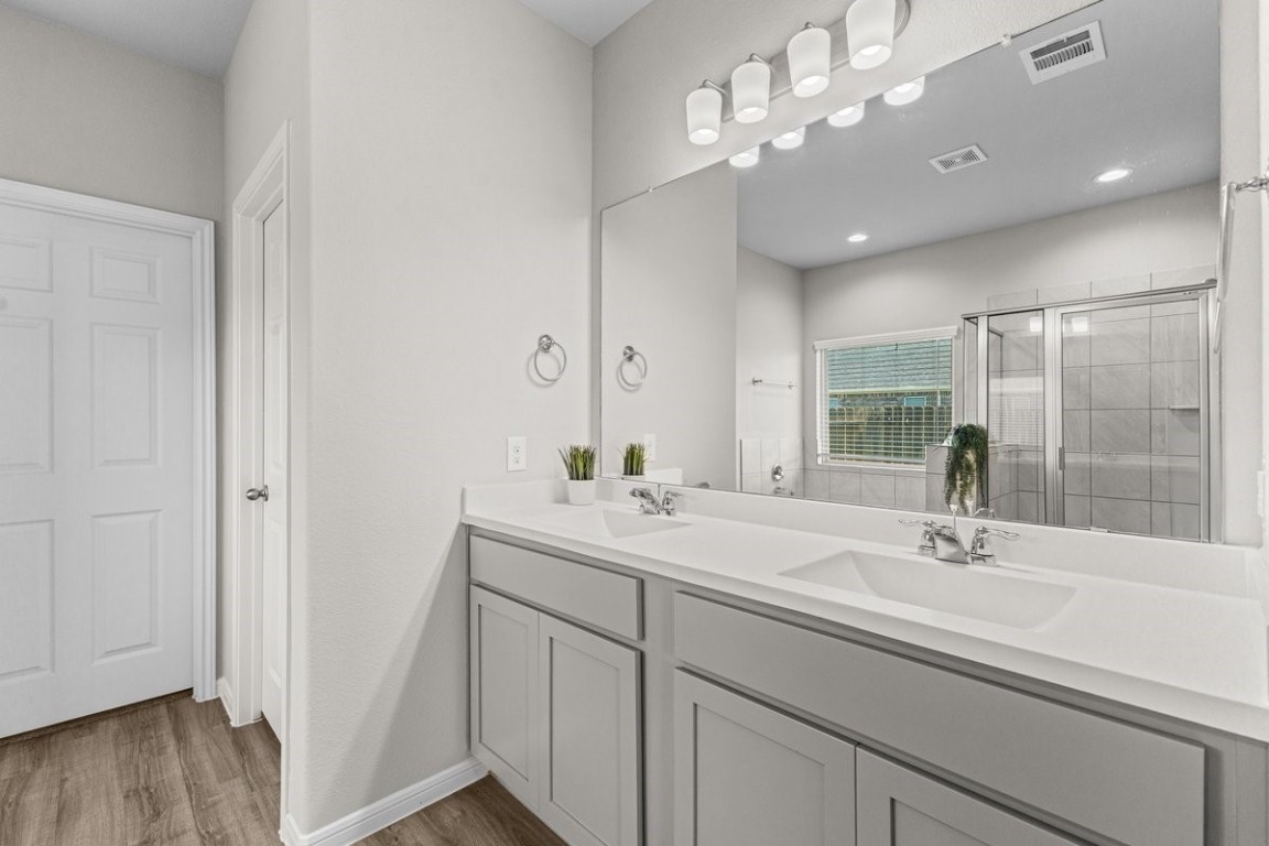 10139 Red Snapper Road Magnolia, TX 77354 - Photo 16 of 27 a bathroom with a sink a light fixture and a mirror