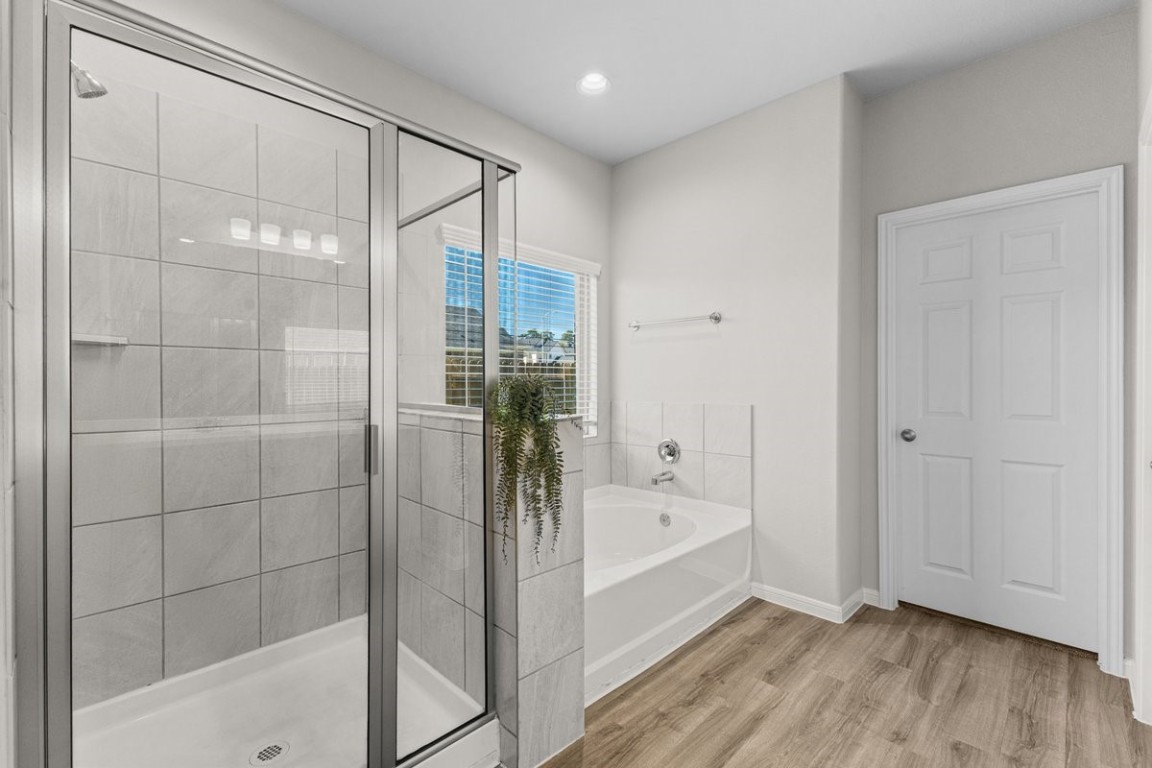 10139 Red Snapper Road Magnolia, TX 77354 - Photo 17 of 27 a bathroom with a bathtub and a shower