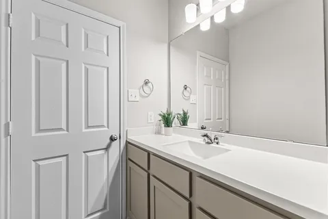 a bathroom with a sink a vanity and a mirror