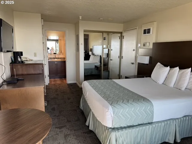 a spacious bedroom with a bed and couch