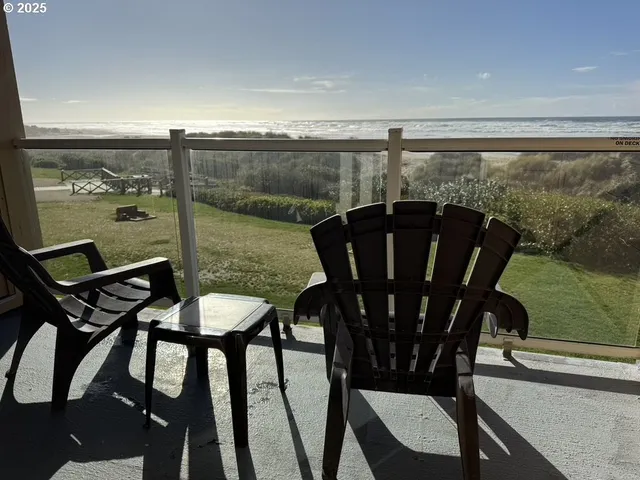 a view of a chairs and table in the balcony