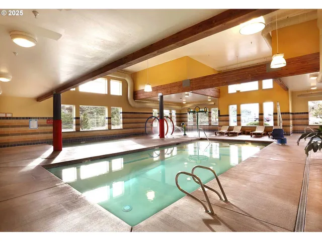a view of a swimming pool and dining room