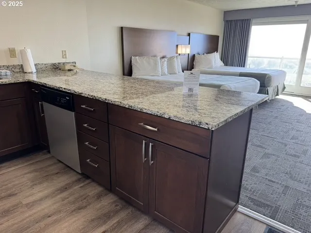a kitchen with granite countertop sink and cabinets