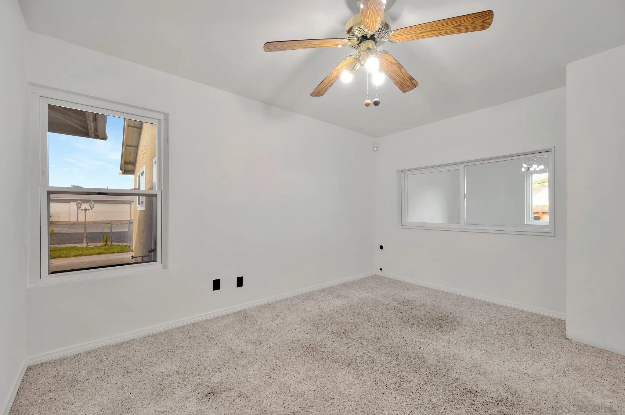 9183 Via De Amor Santee, CA 92071 - Photo 20 of 32 an empty room with a window and a fan