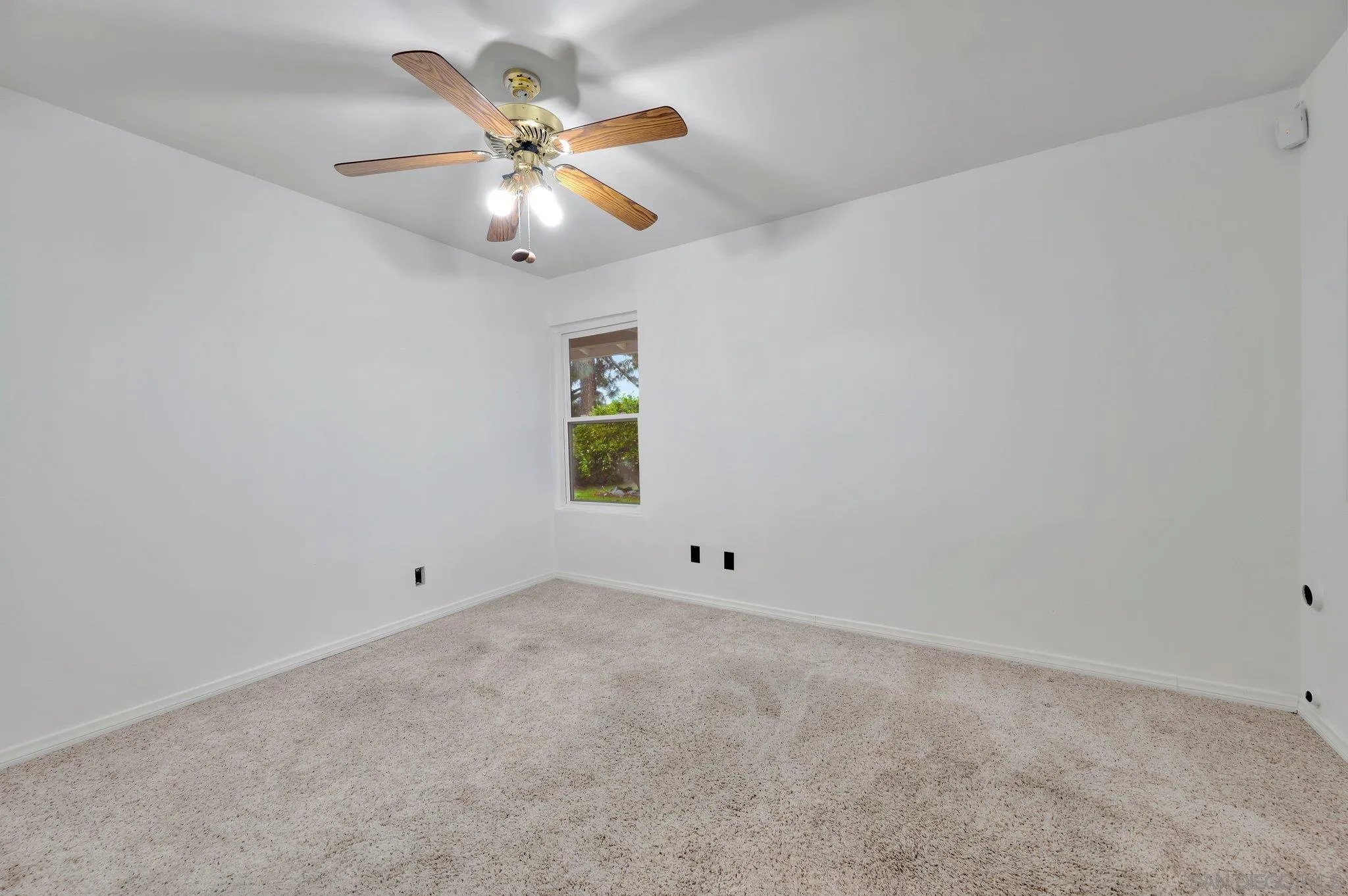 9183 Via De Amor Santee, CA 92071 - Photo 21 of 32 an empty room with a window and a fan