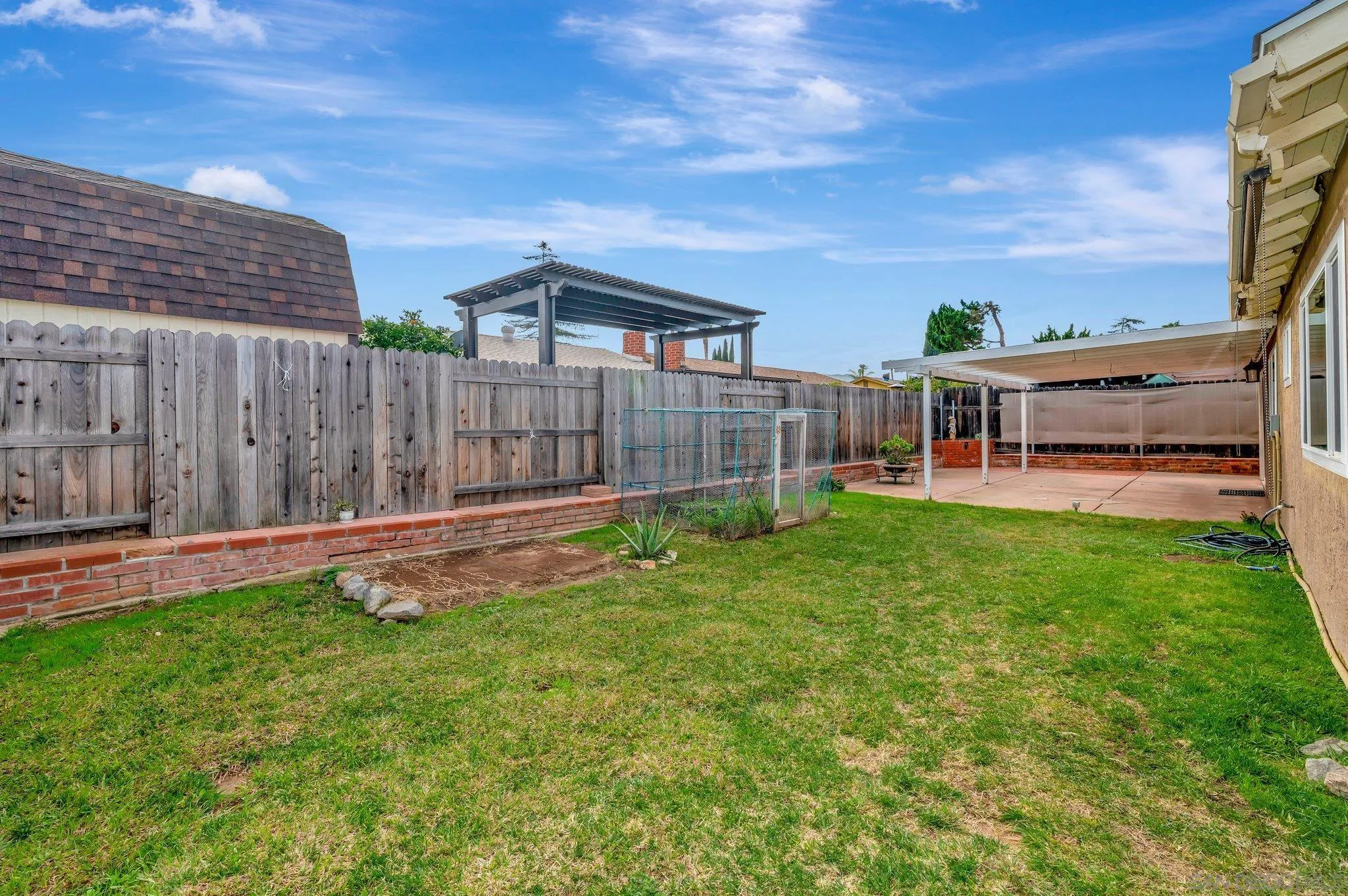 9183 Via De Amor Santee, CA 92071 - Photo 26 of 32 a view of a backyard with a garden and deck