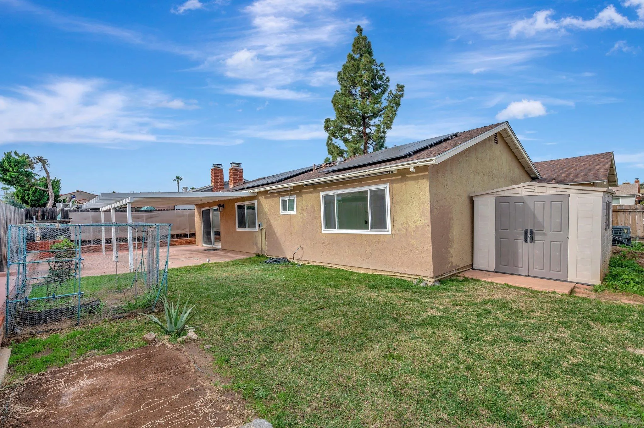 9183 Via De Amor Santee, CA 92071 - Photo 27 of 32 a view of a yard in front of a house with plants and large tree