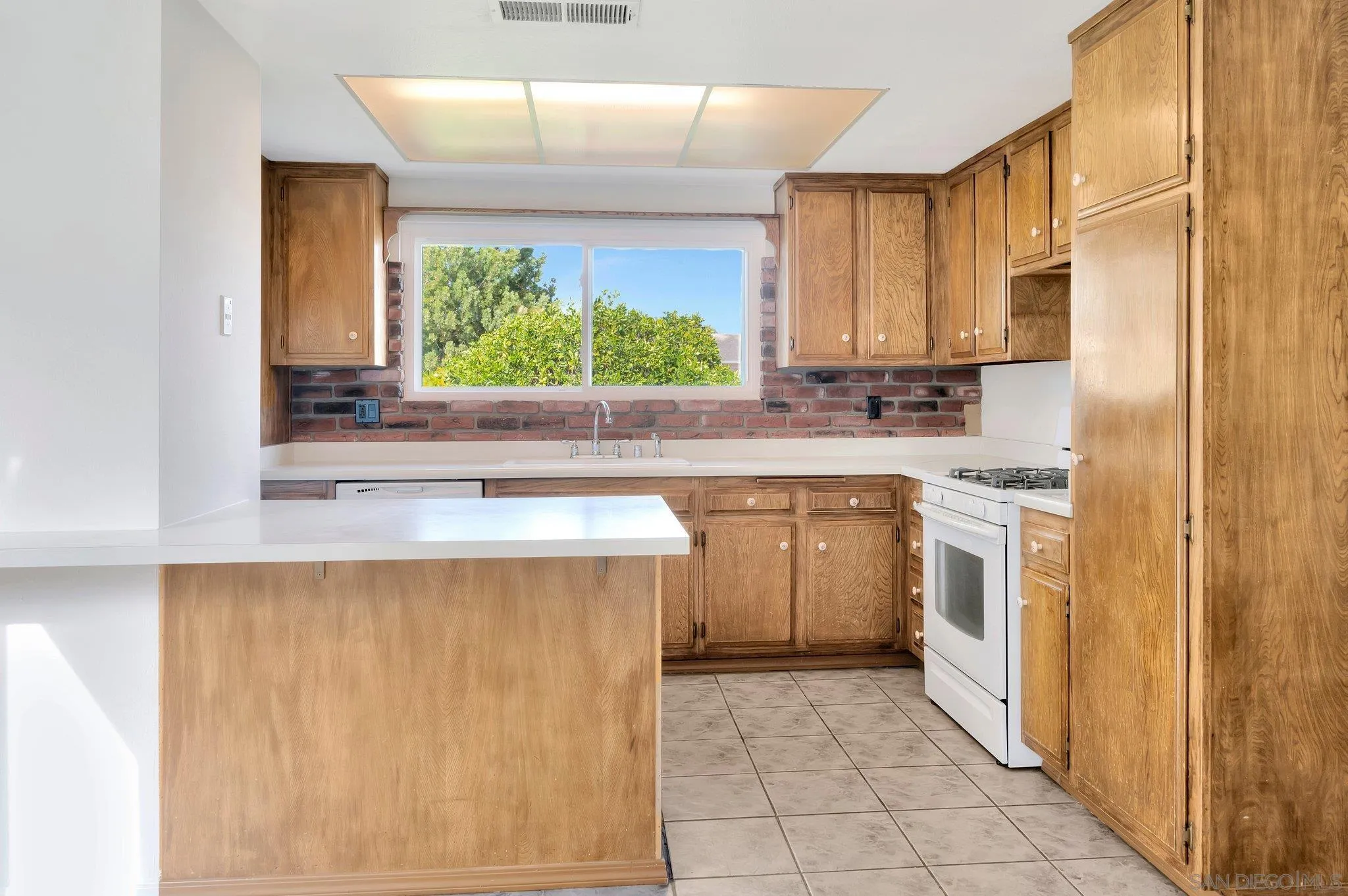 9183 Via De Amor Santee, CA 92071 - Photo 6 of 32 a kitchen with a sink stove and cabinets
