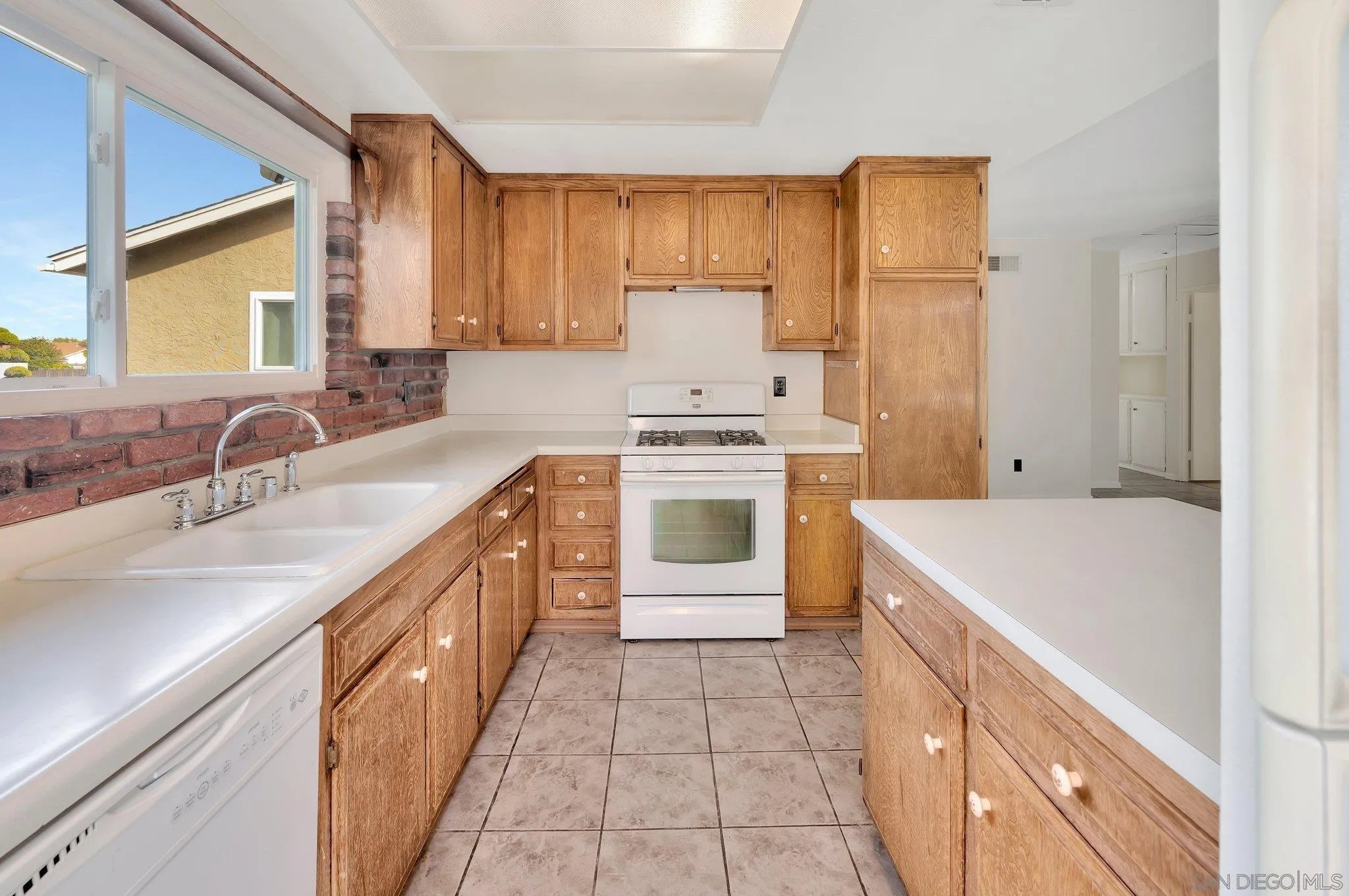 9183 Via De Amor Santee, CA 92071 - Photo 8 of 32 a kitchen with a sink stove and refrigerator