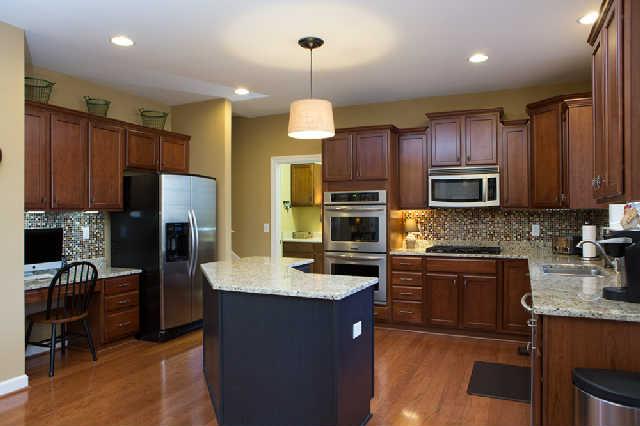 5524 Rathkeale Lane Franklin, TN 37067 - Photo 9 of 20 Open & upscale gourmet kitchen is loaded with every amenity to maximize your enjoyment of this incredible home. Stunning granite, updated backsplash, new stainless double ovens & dishwasher, gas cooktop, under cabinet lighting, eat-at-bar seating.