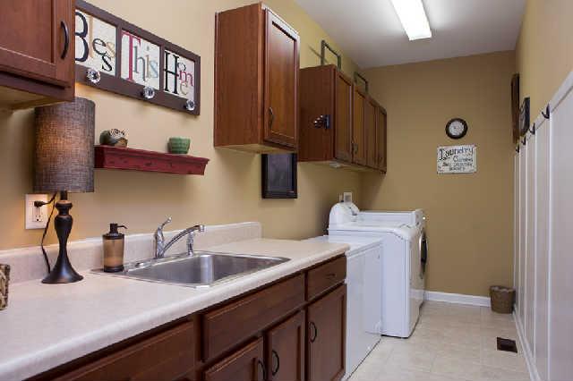 5524 Rathkeale Lane Franklin, TN 37067 - Photo 15 of 20 This large Mud Room/Laundry Room has custom cabinetry, laundry sink & updated craftsman style wall treatment with hooks, perfect for hanging backpacks & coats. Full size washer and dryer remain with the property!