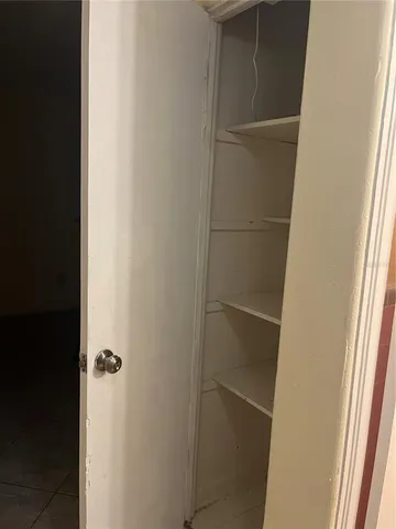 a view of a livingroom with an empty space and a window