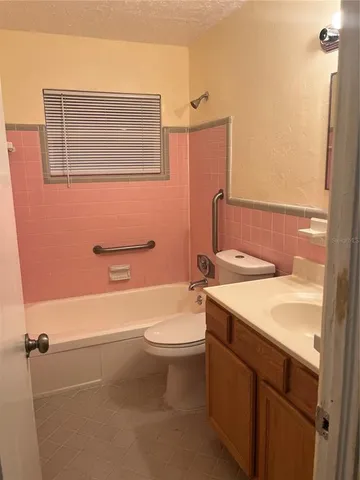 a view of a small space with wooden floor and a window