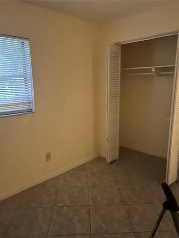 a view of a chair and table in backyard