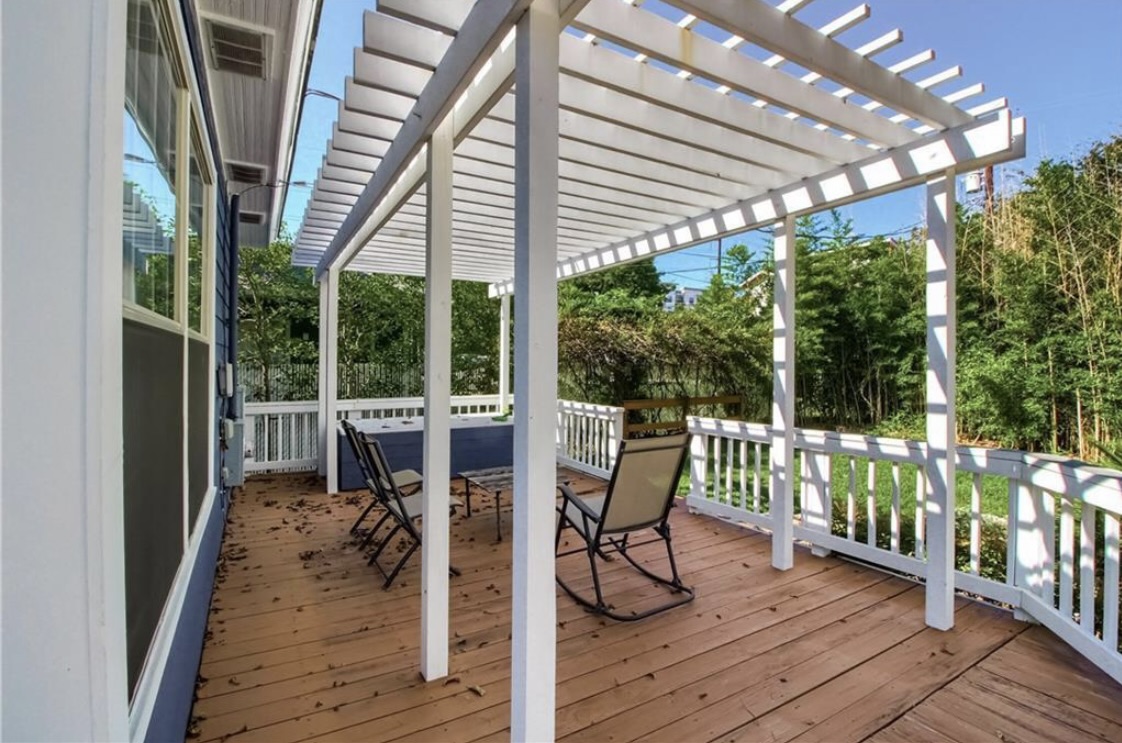 702 West N Loop Boulevard Austin, TX 78751 - Photo 21 of 23 An inviting deck with an open pergola offers a delightful outdoor relaxation space.