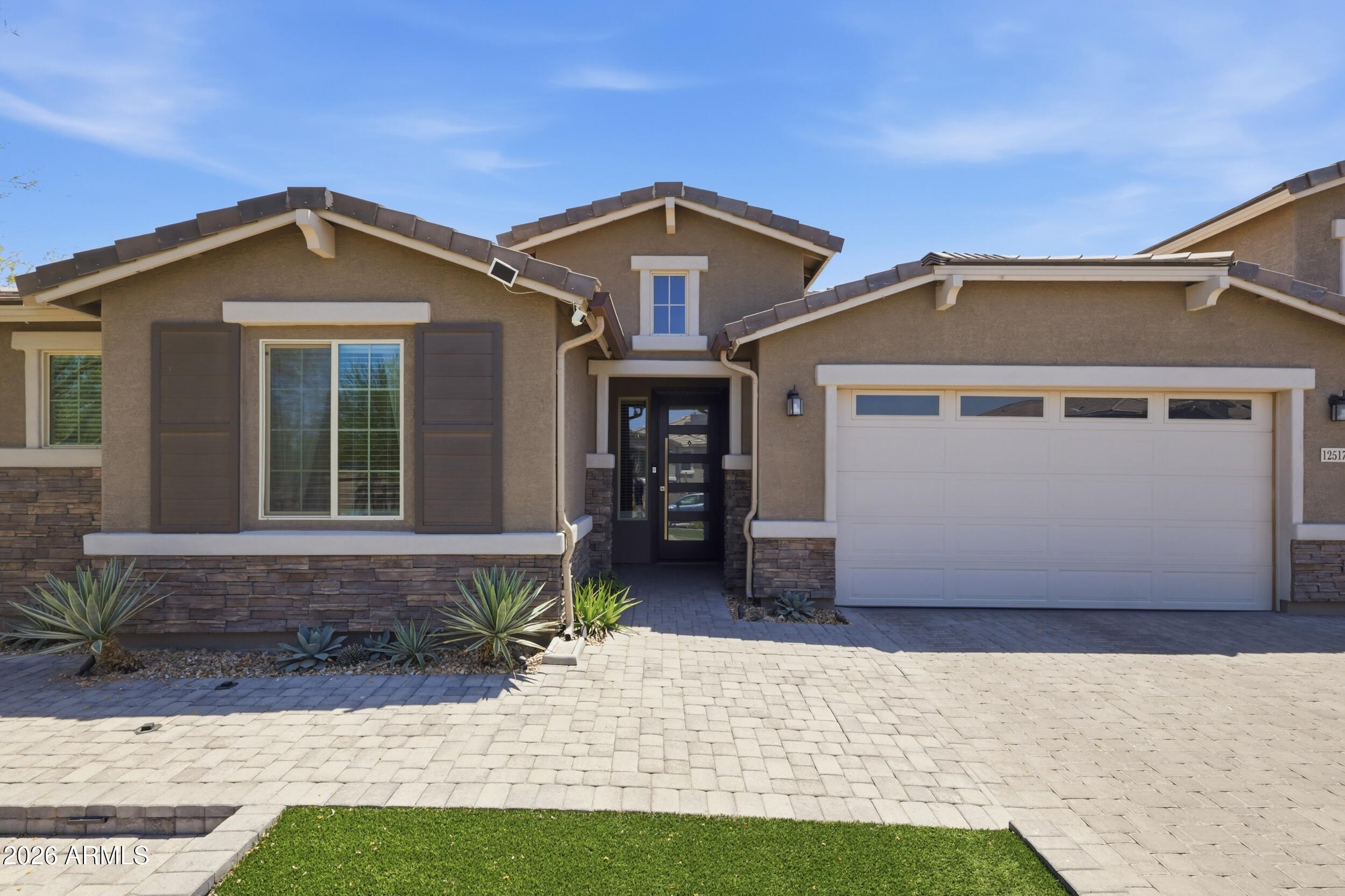 12517 West Lawrence Road Glendale, AZ 85307 - Photo 6 of 52 a front view of a house with a yard and garage