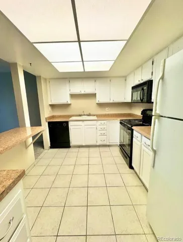 a kitchen with stainless steel appliances a stove a sink and a refrigerator