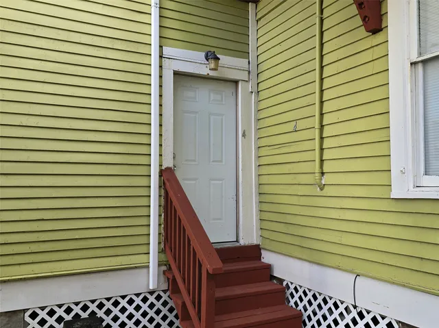 a view of a porch with wooden stairs