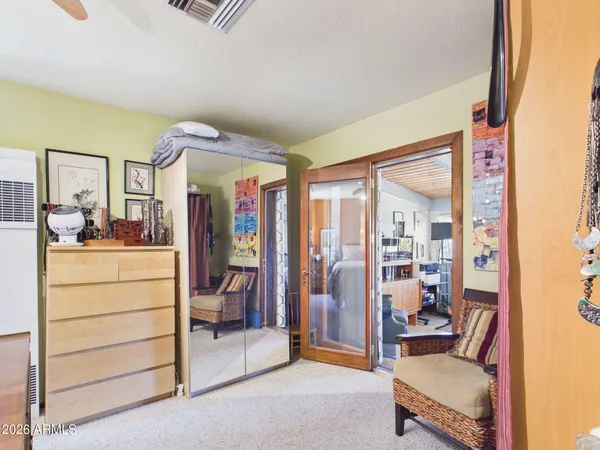a bedroom with a bed and a mirror