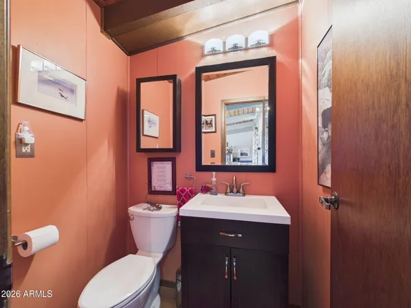 a bathroom with a toilet a sink and mirror
