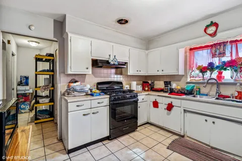 a kitchen with a white stove top oven and cabinets