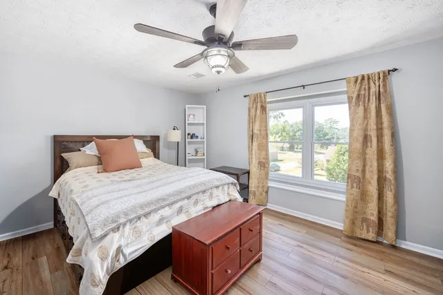 a bed sitting in a bedroom next to a window