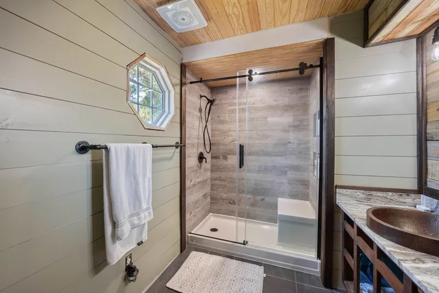 a bathroom with a shower and a sink