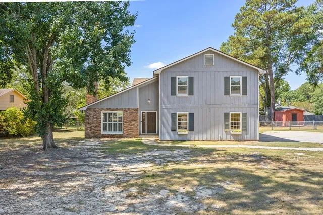 a front view of a house with a garden