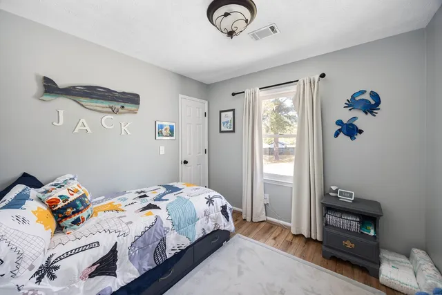 a bedroom with a bed and a window